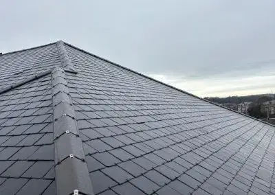 Completed grey slate pitched roof on a residential property